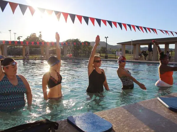 Adults taking a swimming lesson