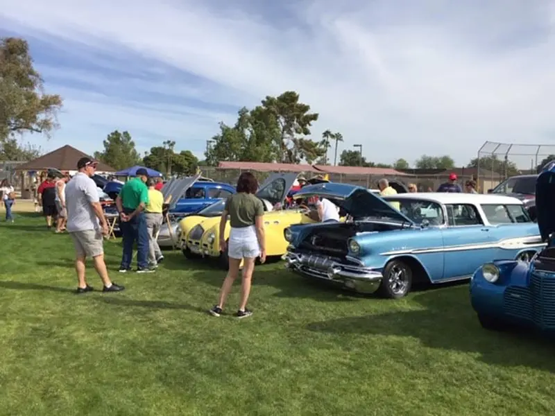 people checking out vintage cars