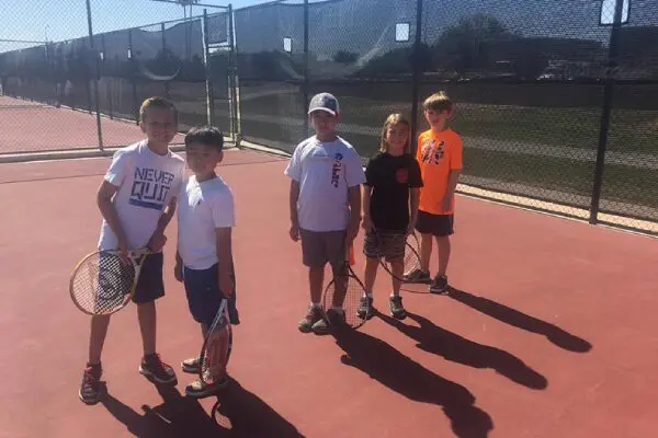 kids holding their tennis rackets