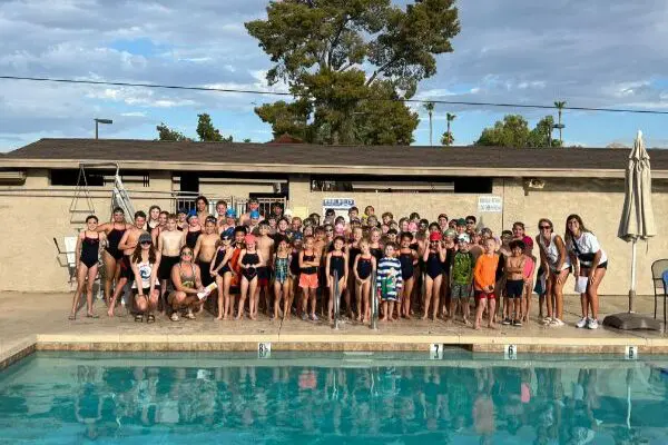 A huge group of people near a swimming pool