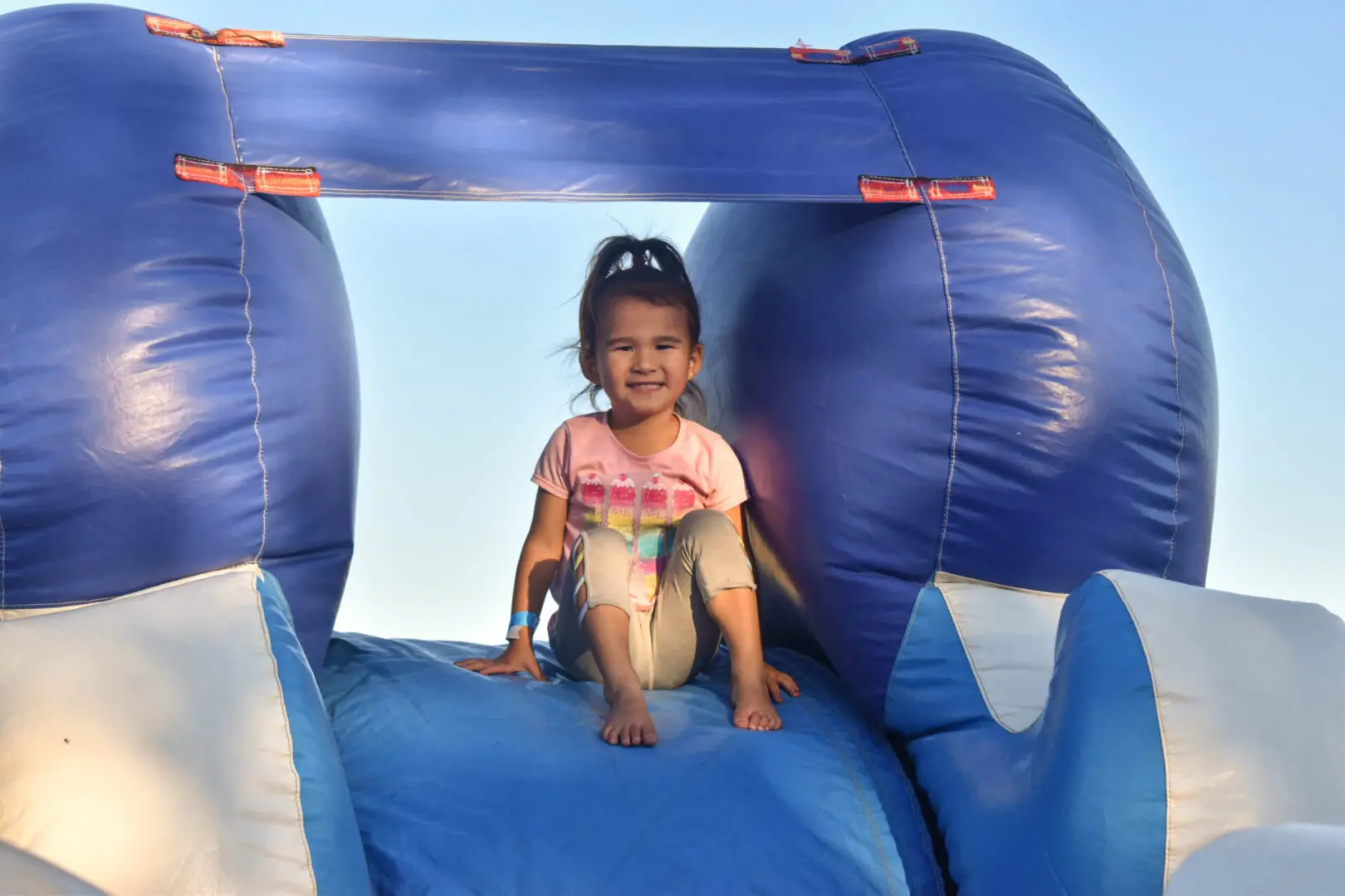 a young girl on an inflatable slide